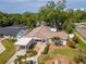 This single-story home boasts a large lot, a carport, a white picket fence, and mature landscaping for privacy at 201 S Treasure E Dr, Tampa, FL 33609