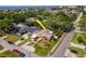 Single-story home, highlighted with an arrow, near the coast showcases mature landscaping, a carport, and coastal living at 201 S Treasure E Dr, Tampa, FL 33609