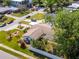 Single-story home features mature landscaping, a carport, and a fenced backyard with lush greenery and shade trees at 201 S Treasure E Dr, Tampa, FL 33609