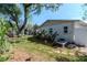 Image of backyard featuring lush tropical landscaping and exterior of home at 201 S Treasure E Dr, Tampa, FL 33609