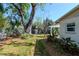 Lush backyard featuring mature trees and manicured landscaping that offers a tranquil outdoor living space at 201 S Treasure E Dr, Tampa, FL 33609