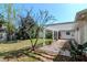 Landscaped backyard with a paved patio area and pergola at 201 S Treasure E Dr, Tampa, FL 33609
