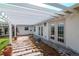 Paver patio with a pergola that is ideal for outdoor gatherings and relaxation at 201 S Treasure E Dr, Tampa, FL 33609