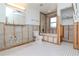Bathroom features tub, toilet and white tiled floors at 201 S Treasure E Dr, Tampa, FL 33609