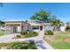 Inviting single-Gathering home with a covered parking area, and walkway to the front entrance at 201 S Treasure E Dr, Tampa, FL 33609
