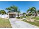 Charming single-story home with a carport and well-manicured front yard, enhancing its curb appeal at 201 S Treasure E Dr, Tampa, FL 33609