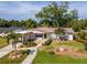 This inviting single-story home showcases tropical landscaping, a brick pathway, and a convenient carport, all on a sunny lot at 201 S Treasure E Dr, Tampa, FL 33609