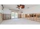 Renovated living room with a ceiling fan, windows, french doors and concrete floors at 201 S Treasure E Dr, Tampa, FL 33609