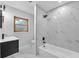 Bathroom features a modern vanity, sleek faucet, framed mirror, and bathtub at 204 7Th Nw Ave, Ruskin, FL 33570