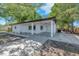 Inviting home exterior featuring a covered porch, long driveway, and manicured landscaping at 204 7Th Nw Ave, Ruskin, FL 33570