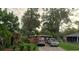 Charming single-story home featuring a classic red brick facade and a well-maintained front yard with mature trees at 2110 Oakley S Ave, St Petersburg, FL 33712