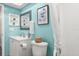 Bathroom with blue walls, vanity, white cabinets, toilet and shower with curtain at 2327 Moore Haven W Dr, Clearwater, FL 33763