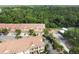 Aerial view of townhomes surrounded by lush greenery and trees in a serene neighborhood setting at 2676 Tanglewood Trl, Palm Harbor, FL 34685