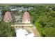 Scenic aerial shot of townhomes nestled amidst lush green trees and a tranquil neighborhood at 2676 Tanglewood Trl, Palm Harbor, FL 34685