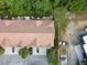 Overhead aerial view of townhomes with tile roofs, manicured landscaping, and plenty of parking at 2676 Tanglewood Trl, Palm Harbor, FL 34685