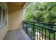 Enjoy the lush green views from this balcony featuring a decorative metal railing and exterior siding at 2676 Tanglewood Trl, Palm Harbor, FL 34685