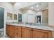 Spacious bathroom featuring a granite countertop double vanity, tile flooring, and access to a glass shower at 2676 Tanglewood Trl, Palm Harbor, FL 34685