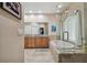 Luxurious bathroom with a soaking tub, granite counters, and a glass-enclosed shower with natural light at 2676 Tanglewood Trl, Palm Harbor, FL 34685