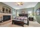 Bedroom boasts a fireplace and mantel, with a window letting in natural light and a comfortable seating area at 2676 Tanglewood Trl, Palm Harbor, FL 34685