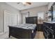 Cozy bedroom featuring a dark wood bed frame, dresser, closet and soft carpeting at 2676 Tanglewood Trl, Palm Harbor, FL 34685