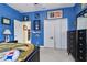 Bedroom showcasing blue walls, a closet, and a doorway leading to another room at 2676 Tanglewood Trl, Palm Harbor, FL 34685