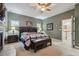 Comfortable bedroom with a fireplace, bench seating, and windows that let in ample natural light at 2676 Tanglewood Trl, Palm Harbor, FL 34685
