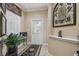 Charming foyer with decorative rug, art niche, and stained glass front door sets a welcoming tone at 2676 Tanglewood Trl, Palm Harbor, FL 34685