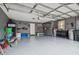 A spacious two car garage with newly painted floor, equipped with wall shelving, and an automatic garage door at 2676 Tanglewood Trl, Palm Harbor, FL 34685