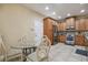 Well-lit kitchen features stainless steel appliances, wood cabinetry and a tile floor plus an adjacent breakfast nook at 2676 Tanglewood Trl, Palm Harbor, FL 34685