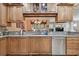 Updated kitchen features granite countertops and a seamless view into the adjacent living room and dining area at 2676 Tanglewood Trl, Palm Harbor, FL 34685