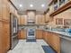 Spacious kitchen features stainless steel appliances, granite counters and tiled flooring and matching cabinets at 2676 Tanglewood Trl, Palm Harbor, FL 34685