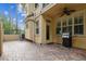 Paver patio with outdoor grill, ceiling fan and neutral exterior at 2676 Tanglewood Trl, Palm Harbor, FL 34685