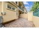 Paver patio surrounded by neutral exterior walls and secure fencing at 2676 Tanglewood Trl, Palm Harbor, FL 34685