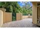 A private brick patio with a gated entrance and lush landscaping provides a tranquil outdoor space at 2676 Tanglewood Trl, Palm Harbor, FL 34685