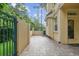 Paver patio with secure fenced wall providing privacy and a cozy exterior space at 2676 Tanglewood Trl, Palm Harbor, FL 34685