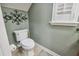 Powder room with tiled floor and walls and a clean, modern toilet at 2676 Tanglewood Trl, Palm Harbor, FL 34685