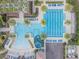 Stunning aerial view of community pool, waterslide, palm trees, lounge chairs and meticulously maintained grounds at 28923 Lucero Ln, Wesley Chapel, FL 33543