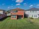 Grassy backyard featuring a covered patio and charming two-story home at 28923 Lucero Ln, Wesley Chapel, FL 33543