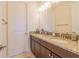 Bathroom with dual sinks, granite counters, tile floor, and ample counter space and storage at 28923 Lucero Ln, Wesley Chapel, FL 33543