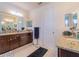 Spacious bathroom with double vanities, granite countertops, and ample storage space at 28923 Lucero Ln, Wesley Chapel, FL 33543