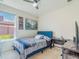 Bedroom with a blue upholstered bed frame, window view and a desk area at 28923 Lucero Ln, Wesley Chapel, FL 33543