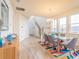 Bright dining room featuring modern decor, stylish furnishings, and staircase view at 28923 Lucero Ln, Wesley Chapel, FL 33543