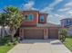 Charming two-story home featuring a three-car garage, neutral color palette, and meticulously maintained landscaping at 28923 Lucero Ln, Wesley Chapel, FL 33543