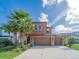 Charming two-story home with a three-car garage, stucco facade, and lush landscaping at 28923 Lucero Ln, Wesley Chapel, FL 33543