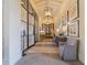 Hallway with elegant lighting, tasteful artwork, and comfortable seating at 28923 Lucero Ln, Wesley Chapel, FL 33543