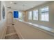 Bright upstairs hallway with neutral walls and carpets and multiple windows at 28923 Lucero Ln, Wesley Chapel, FL 33543