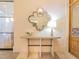 Stylish hallway with decorative mirror, console table, and hardwood door at 28923 Lucero Ln, Wesley Chapel, FL 33543