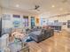 Comfortable living room with a sectional sofa, modern ceiling fan, and an open floor plan at 28923 Lucero Ln, Wesley Chapel, FL 33543