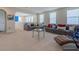 Spacious living room with plush seating, neutral carpet, and plenty of natural light at 28923 Lucero Ln, Wesley Chapel, FL 33543