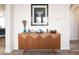 Stylish living room credenza decorated with vases, flowers, and modern abstract art at 28923 Lucero Ln, Wesley Chapel, FL 33543